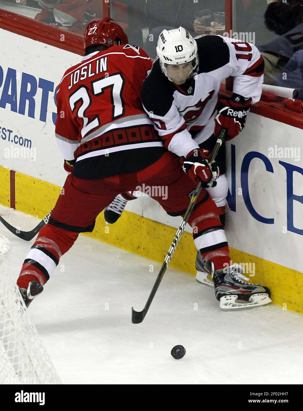 The Carolina Hurricanes' Derek Joslin (27) battles the New Jersey Devils'  Peter Harrold (10) for the puck during the third period at the PNC Arena in  Raleigh, North Carolina, Saturday, March 31,