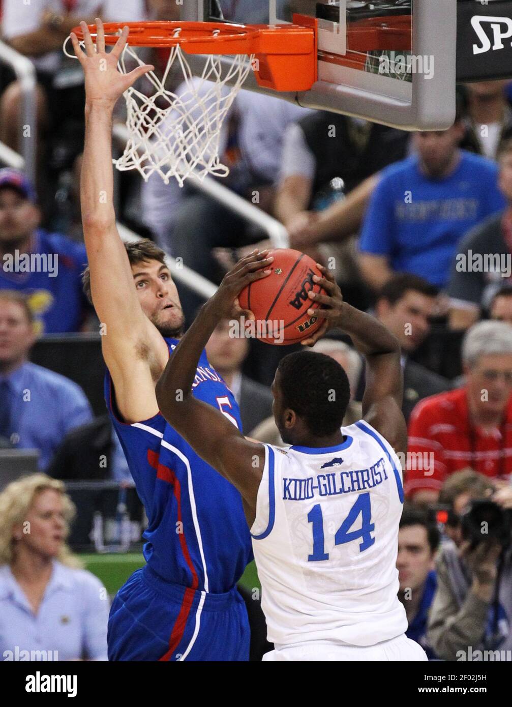 Jeff Withey of Kansas challenges a shot by Michael Kidd-Gilchrist (14 ...