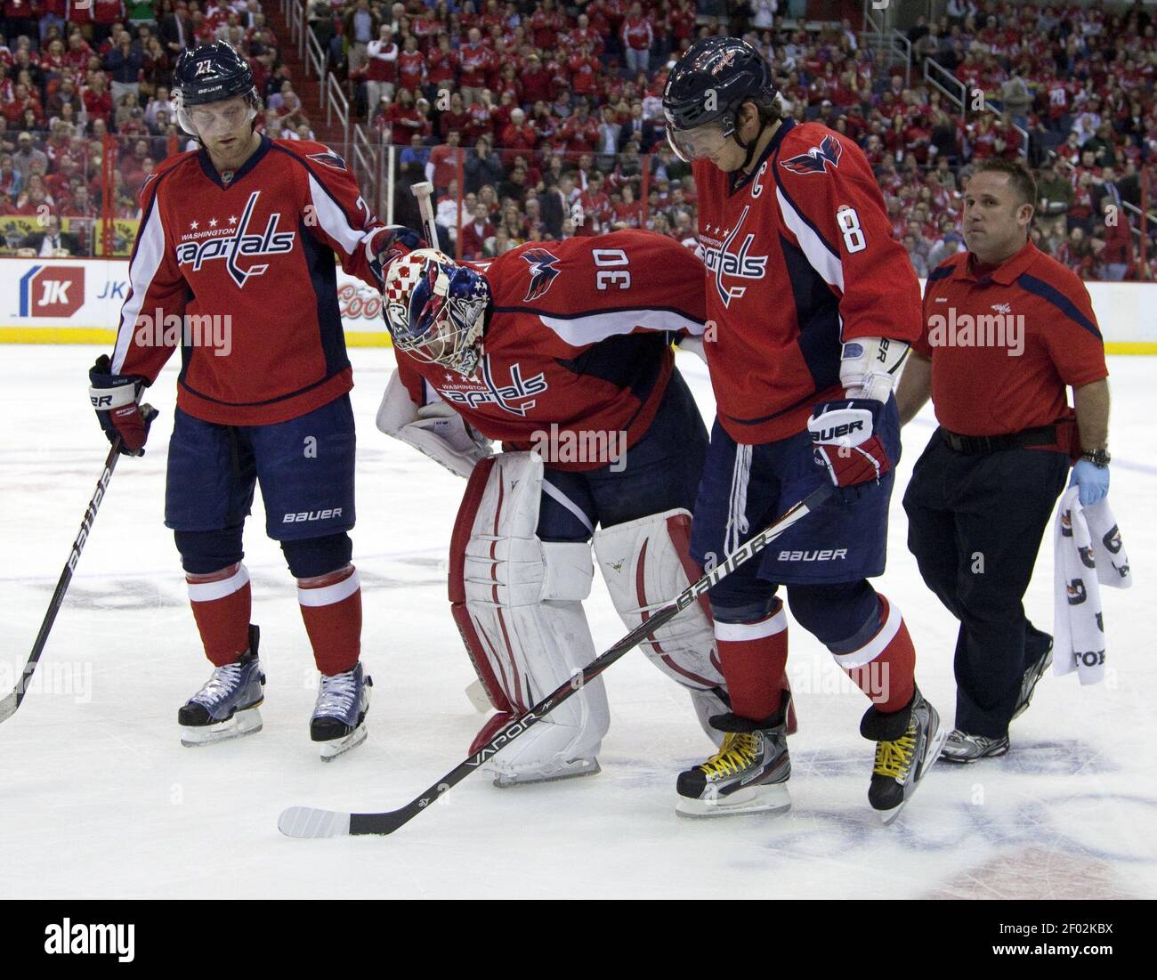 Washington Capitals goalie Michal Neuvirth (30) is assisted off the ice