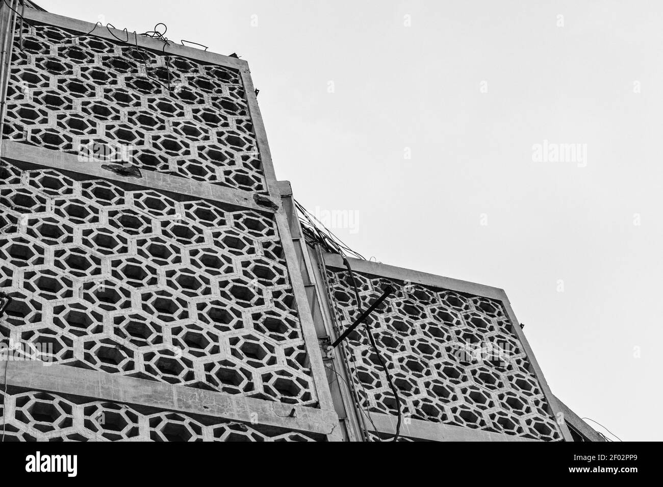 A greyscale low angle shot of a building with a patterned facade Stock Photo