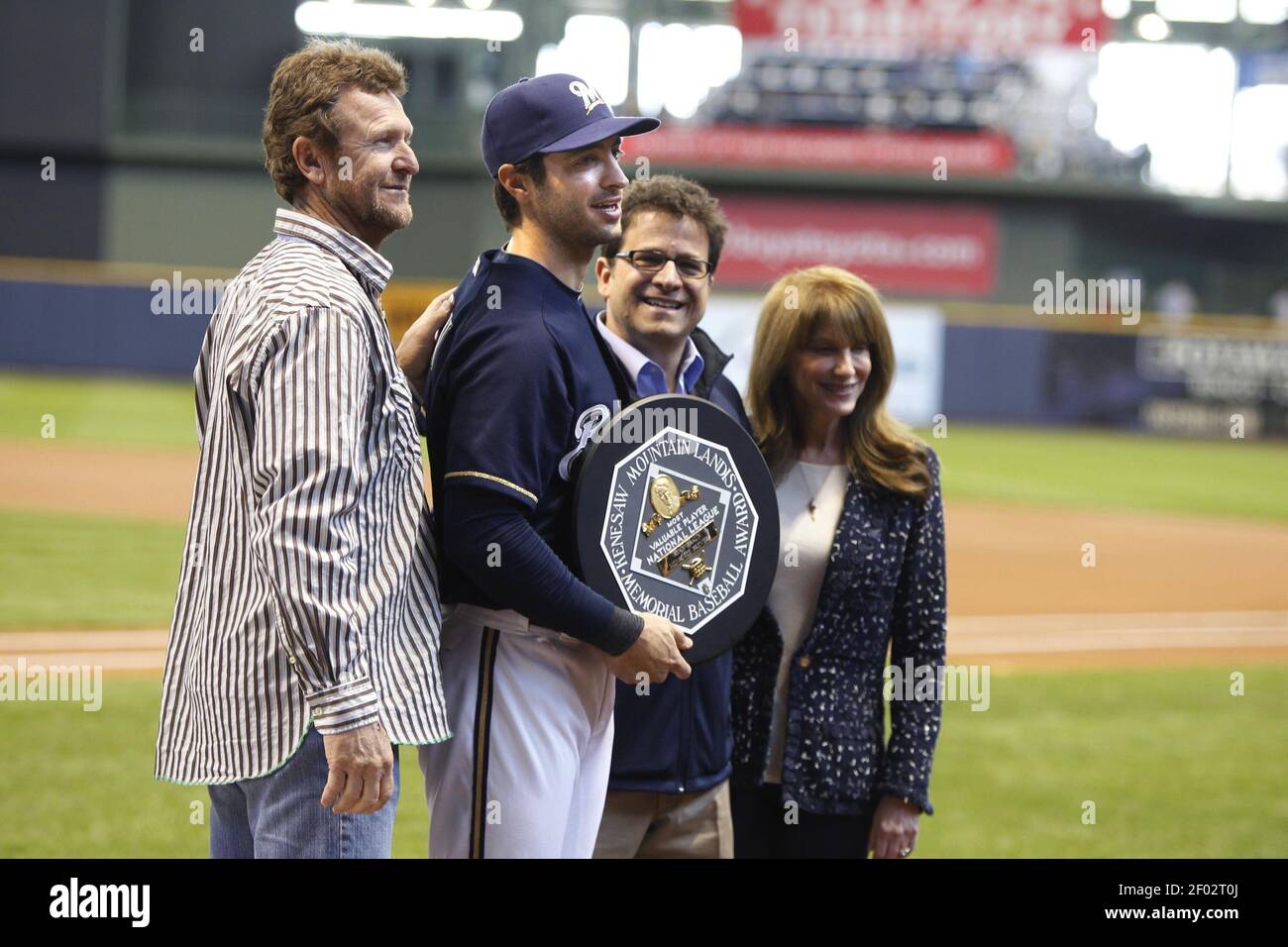 The Milwaukee Brewers' Ryan Braun is presented the National League MVP  award by Brewers owner Mark Attanasio, his wife, Debbie, and former Brewer  Robin Yount in ceremonies before the start of play