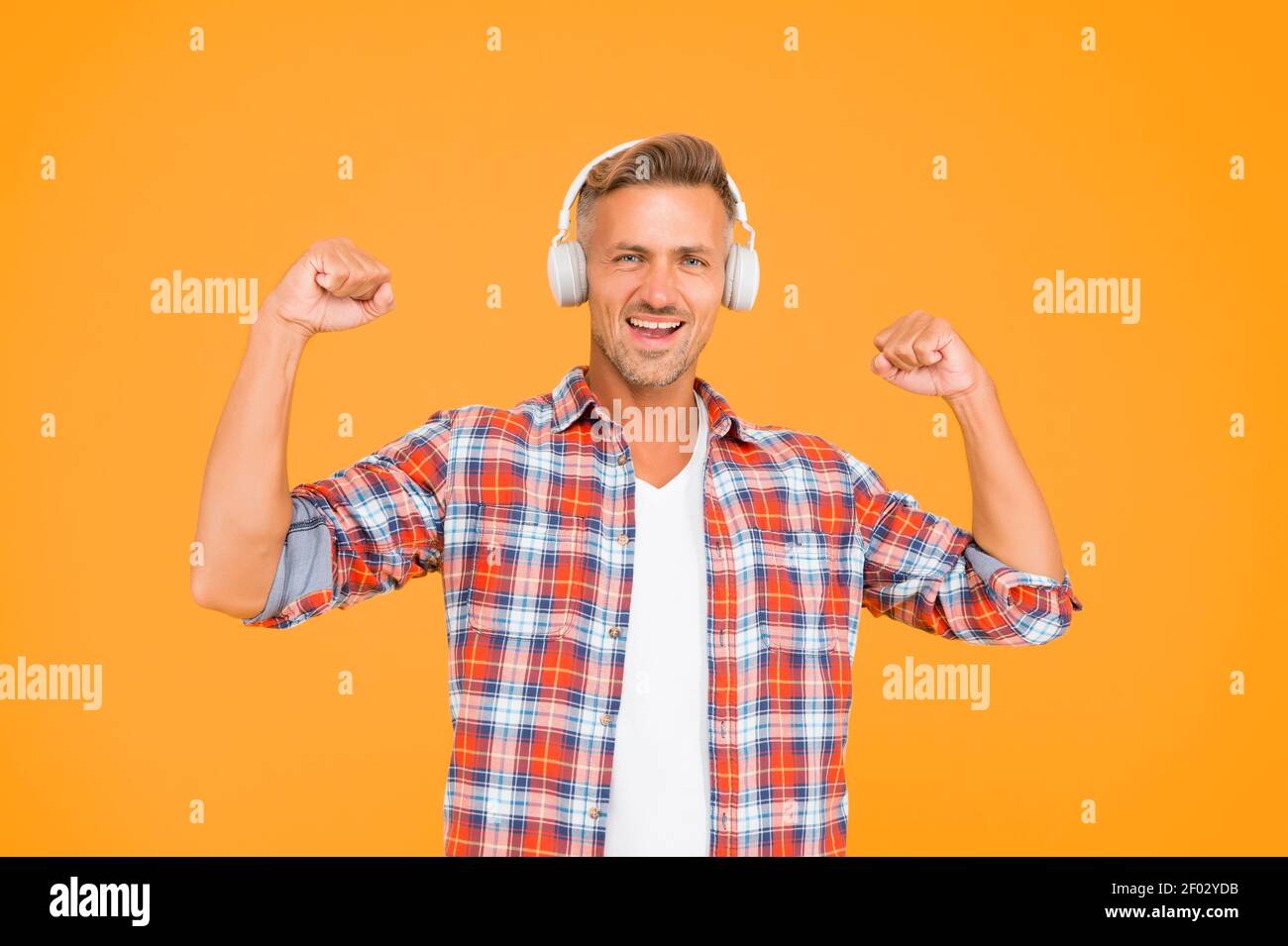 Happy Man Flex Strong Arms Listening To Music In Modern Headphones Yellow Background Sound Power Stock Photo Alamy
