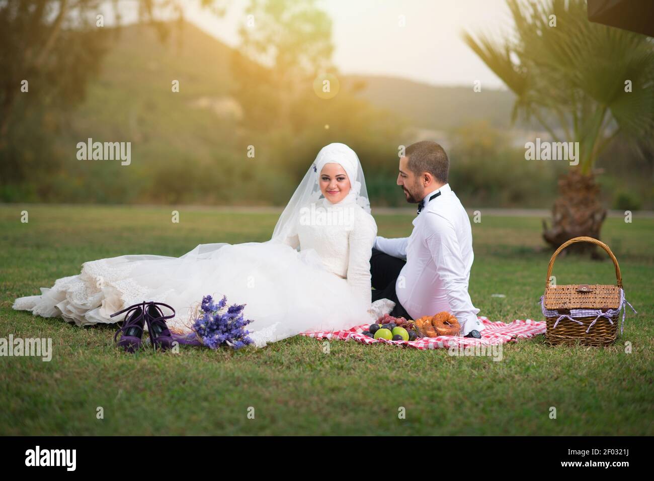 IZMIR, TURKEY - Sep 08, 2017: Young muslim bride and groom wedding photos, outdoors casual clothing and fromal wedding dress and suit. Stock Photo