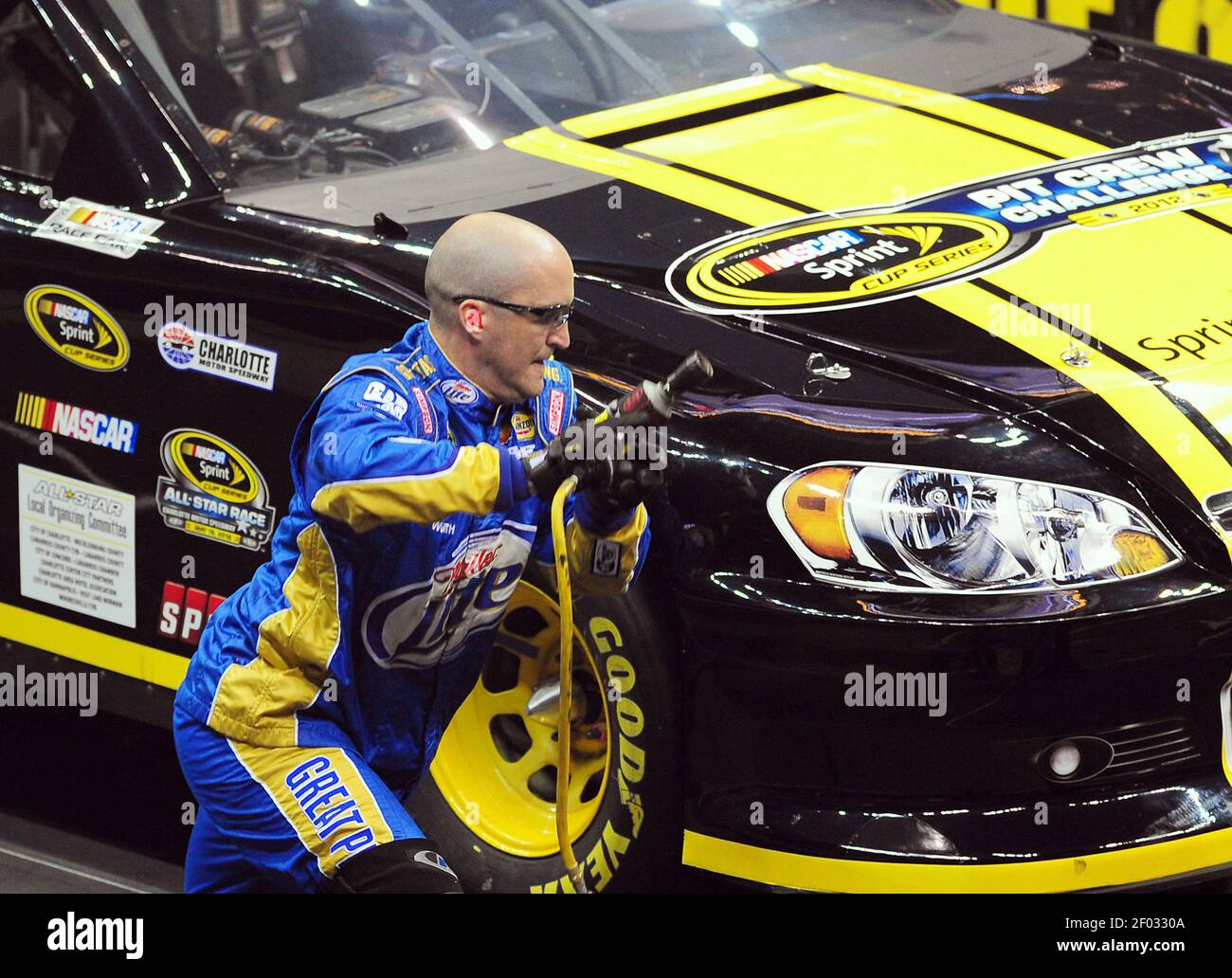 Miller Lite front tire changer Ben Brown hurries around a car to change