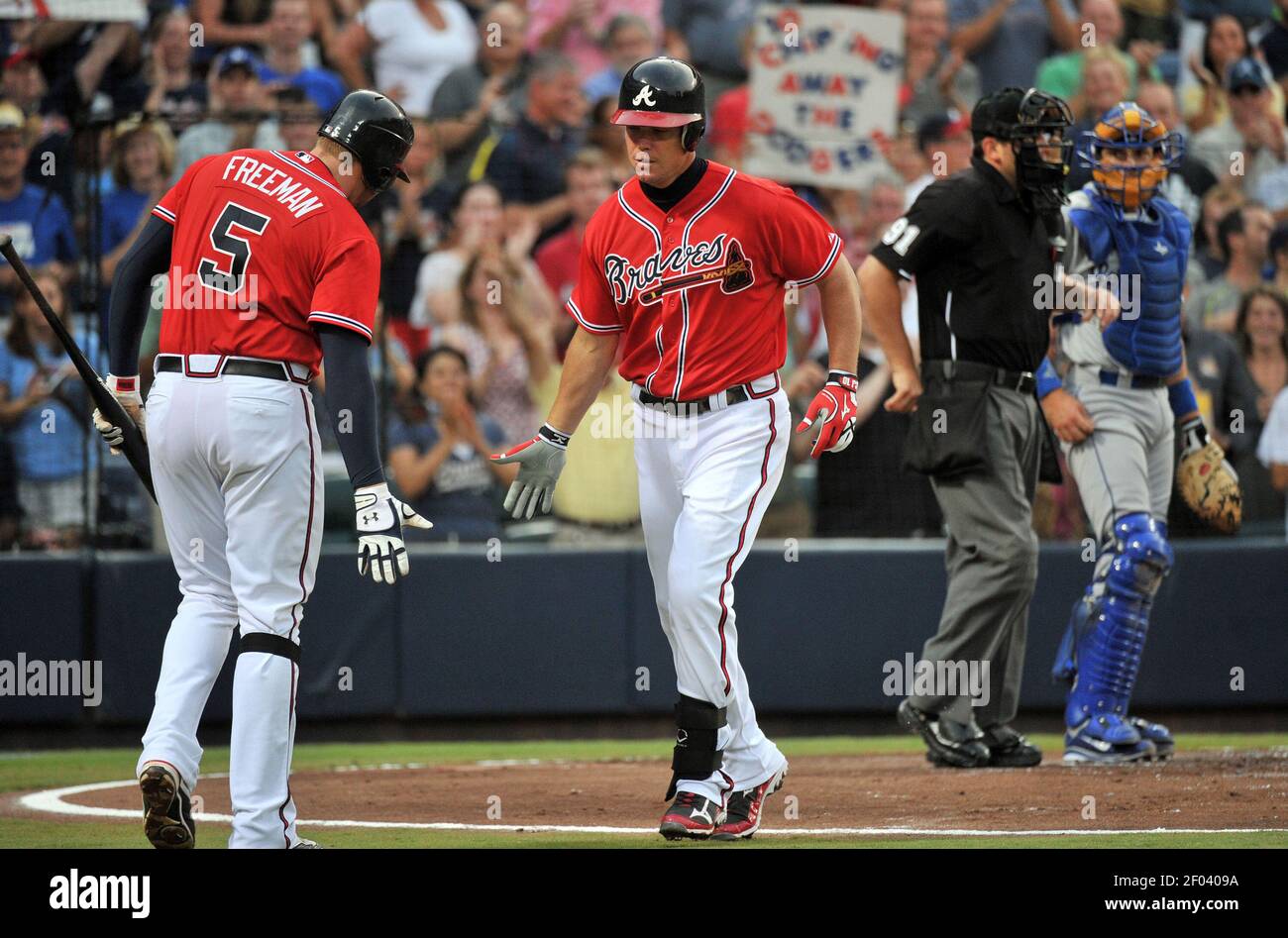 The Atlanta Braves' Chipper Jones is congratulated by teammate Freddie  Freeman (5) after his solo home run in the second inning against the Los  Angeles Dodgers at Turner Field in Atlanta, Georgia