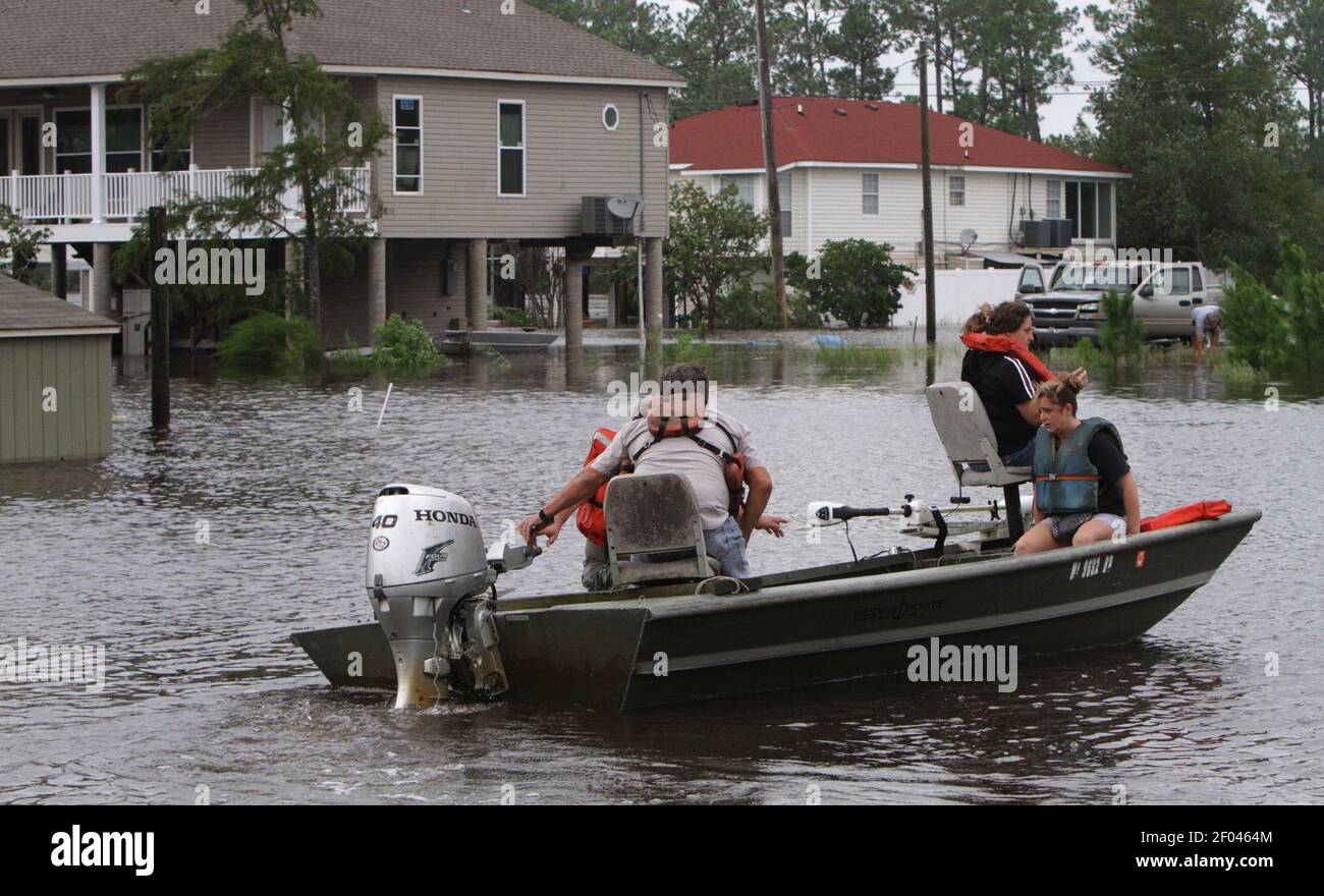 Residents of Jourdan River Estates in Kiln, Mississippi take a boat to
