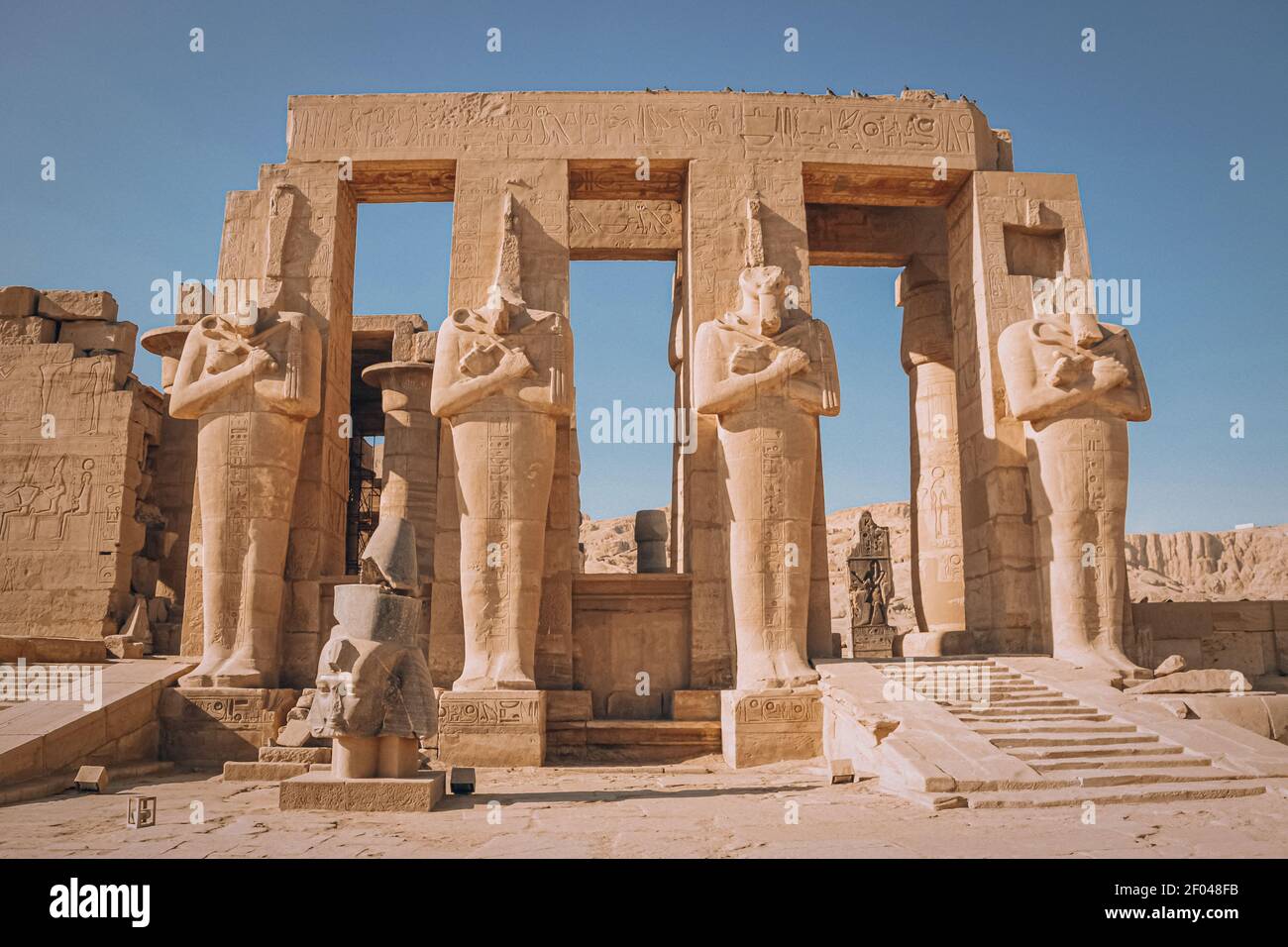 Ruins of the Egyptian temple of Ramesseum, the funeral temple of Pharaoh Ramses II XIII century BC , near the modern city of Luxor. Stock Photo