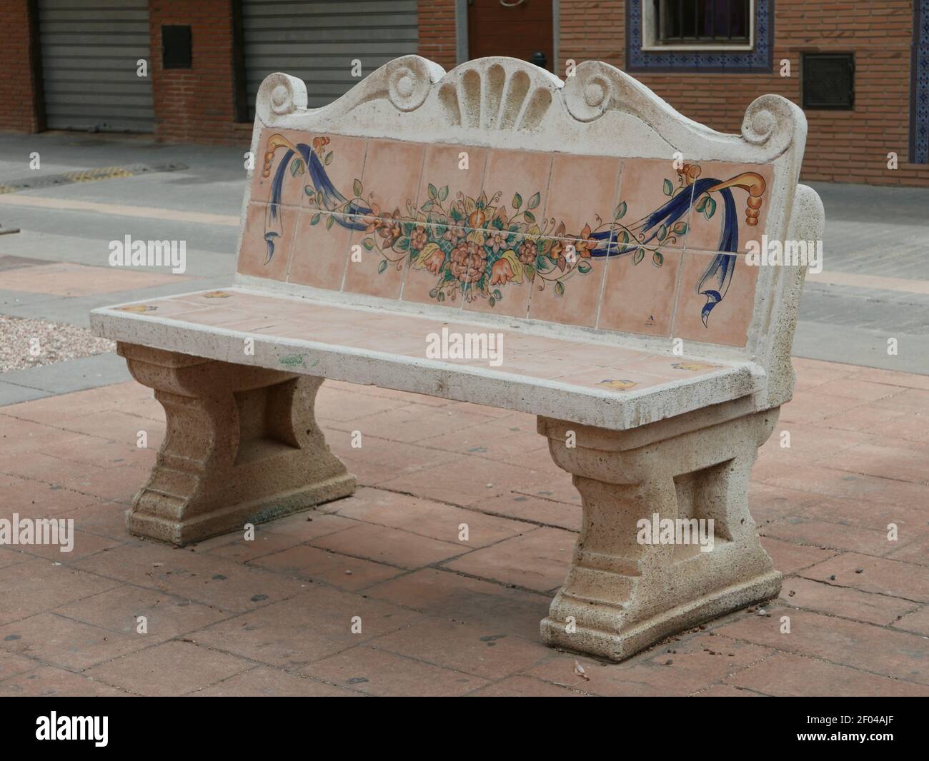 A bench with a drawing on the back in the middle of the city Stock Photo