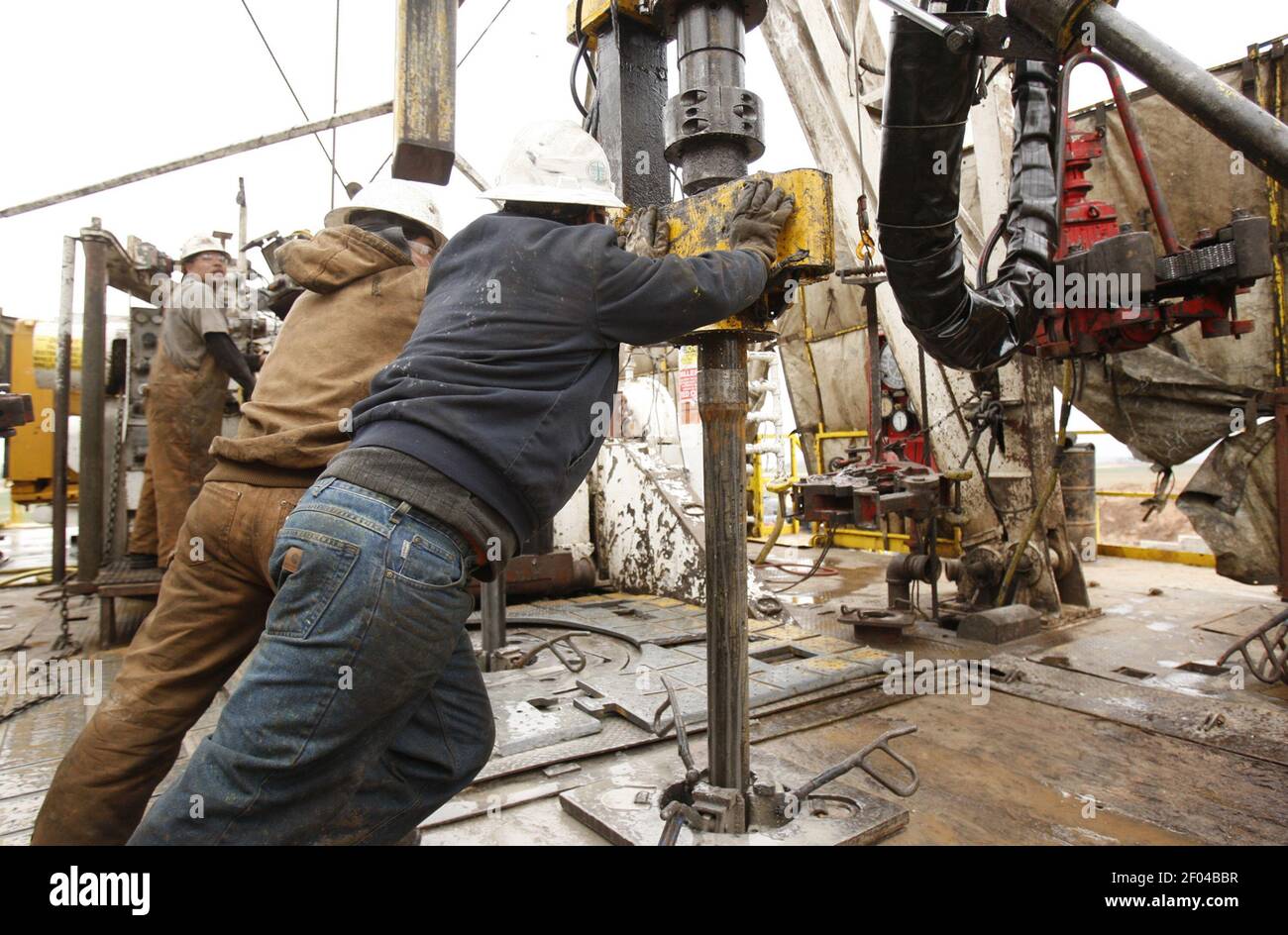 Rig workers change out drill pipe on a rig in Anthony, Kansas, in