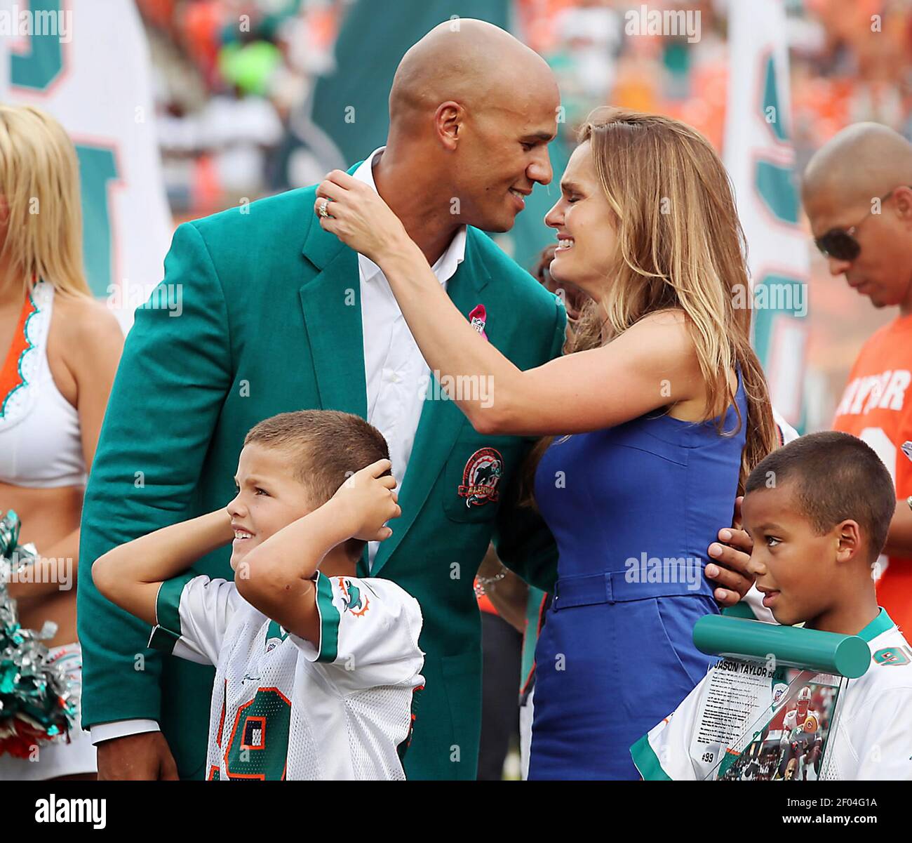 Former Miami Dolphins player Jason Taylor goes to kiss his wife, Katina