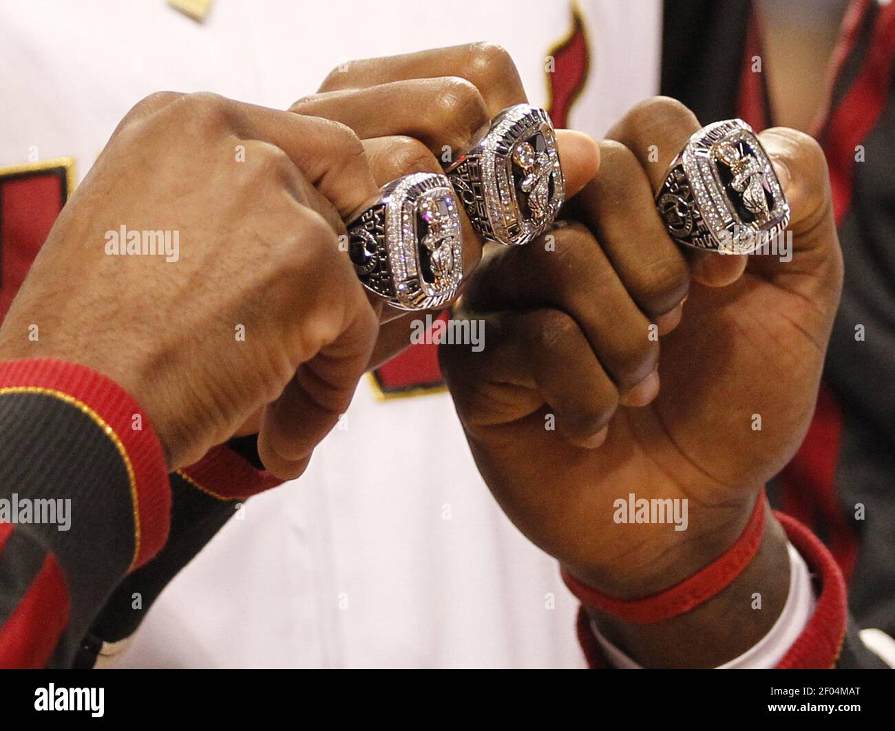 The Miami Heat's Dwyane Wade, Chris Bosh and LeBron James show their NBA Championship  rings during a ceremony at the American Airlines Arena in Miami, Florida,  before the season-opener against the Boston