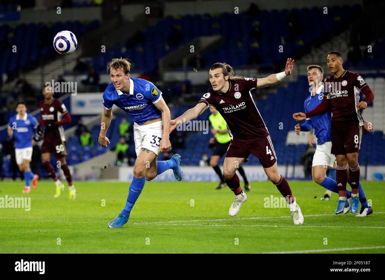 Brighton and Hove Albion's Dan Burn (left) and Leicester City's Caglar Soyuncu battle for the ball during the Premier League match at the American Express Community Stadium, Brighton. Picture date: Saturday March 6, 2021. Stock Photo