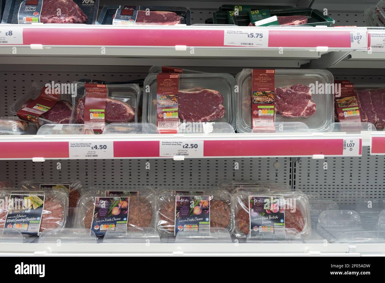 prepacked beef steaks and minced beef burgers display on shelves for sale at sainsbury's