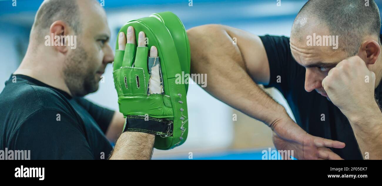 Elbow kick technique training with focus mitts. Elbow strike and punch