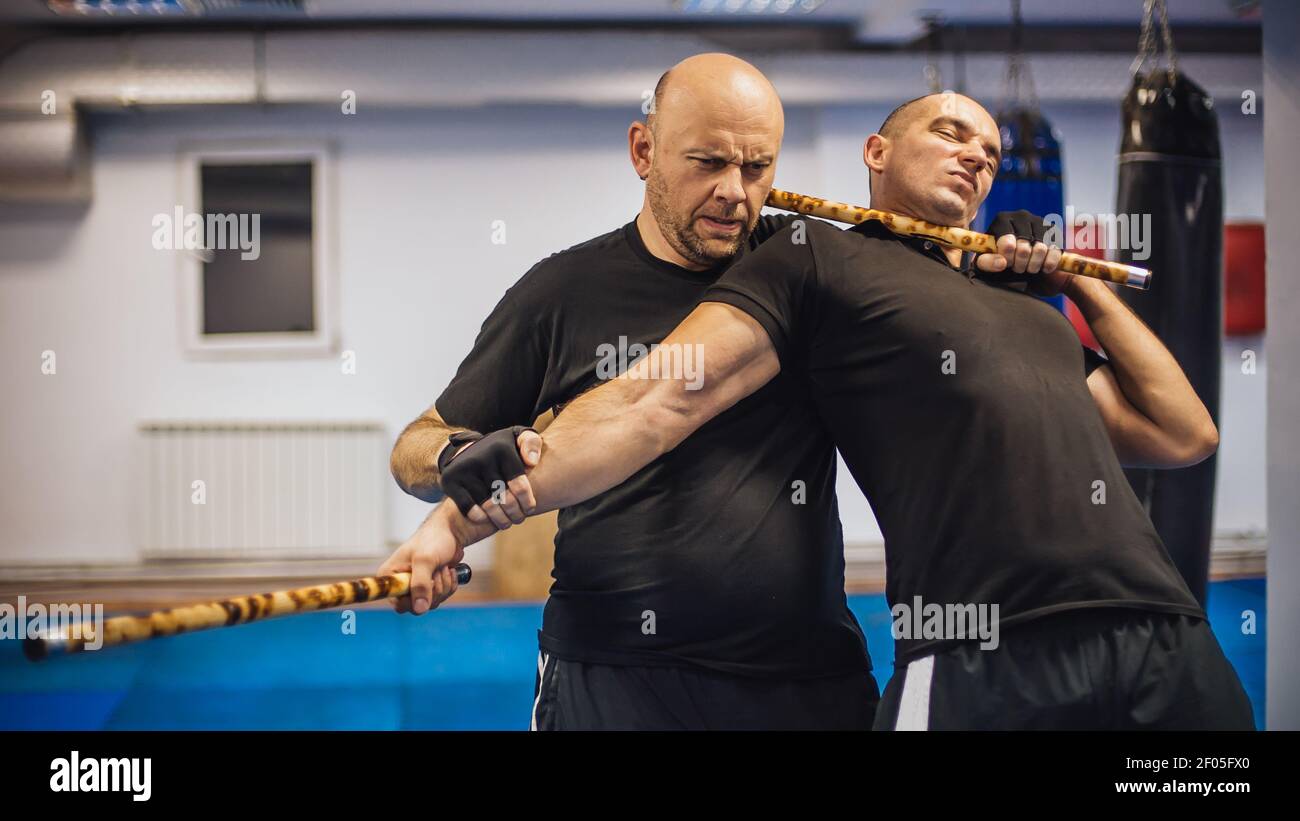 Instructor and student practice filipino escrima stick fighting technique.  Martial arts demonstration Stock Photo - Alamy