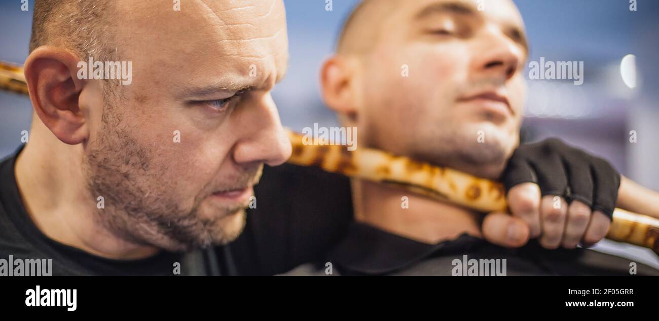 Instructor and student practice filipino escrima stick fighting