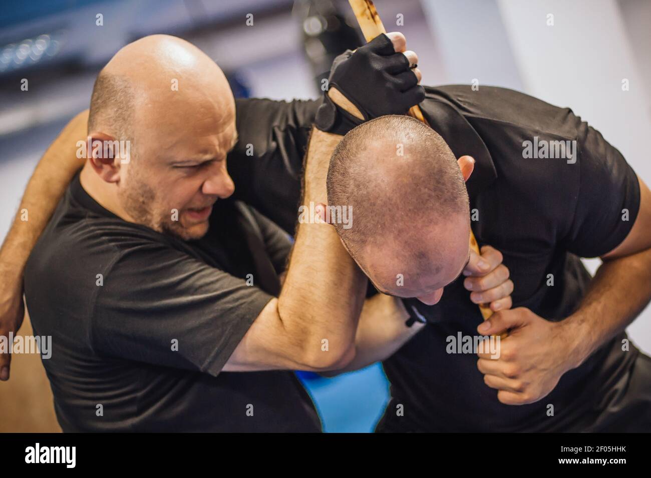 Instructor and student practice filipino escrima stick fighting