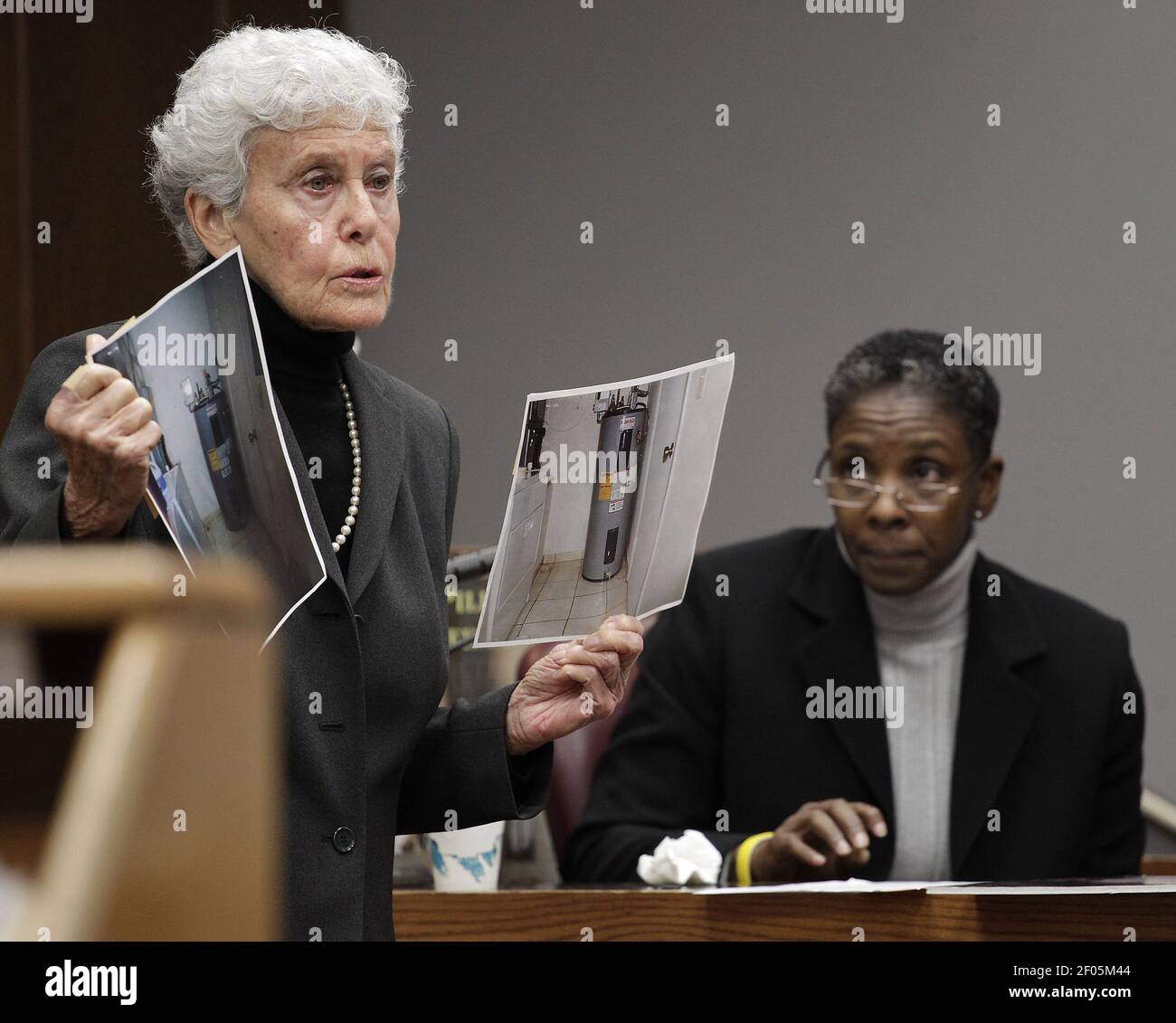 Florida state attorney Sally Weintraub, left, shows the jury photos of the laundry room where Rilya Wilson was kept for days as Pamela Graham, right, testifies in Miami, Florida on Monday, December 17, 2012. Geralyn Graham, not pictured, is charged with the murder of four-year-old Rilya Wilson. (Photo by Carl Juste/Miami Herald/MCT/Sipa USA) Stock Photo