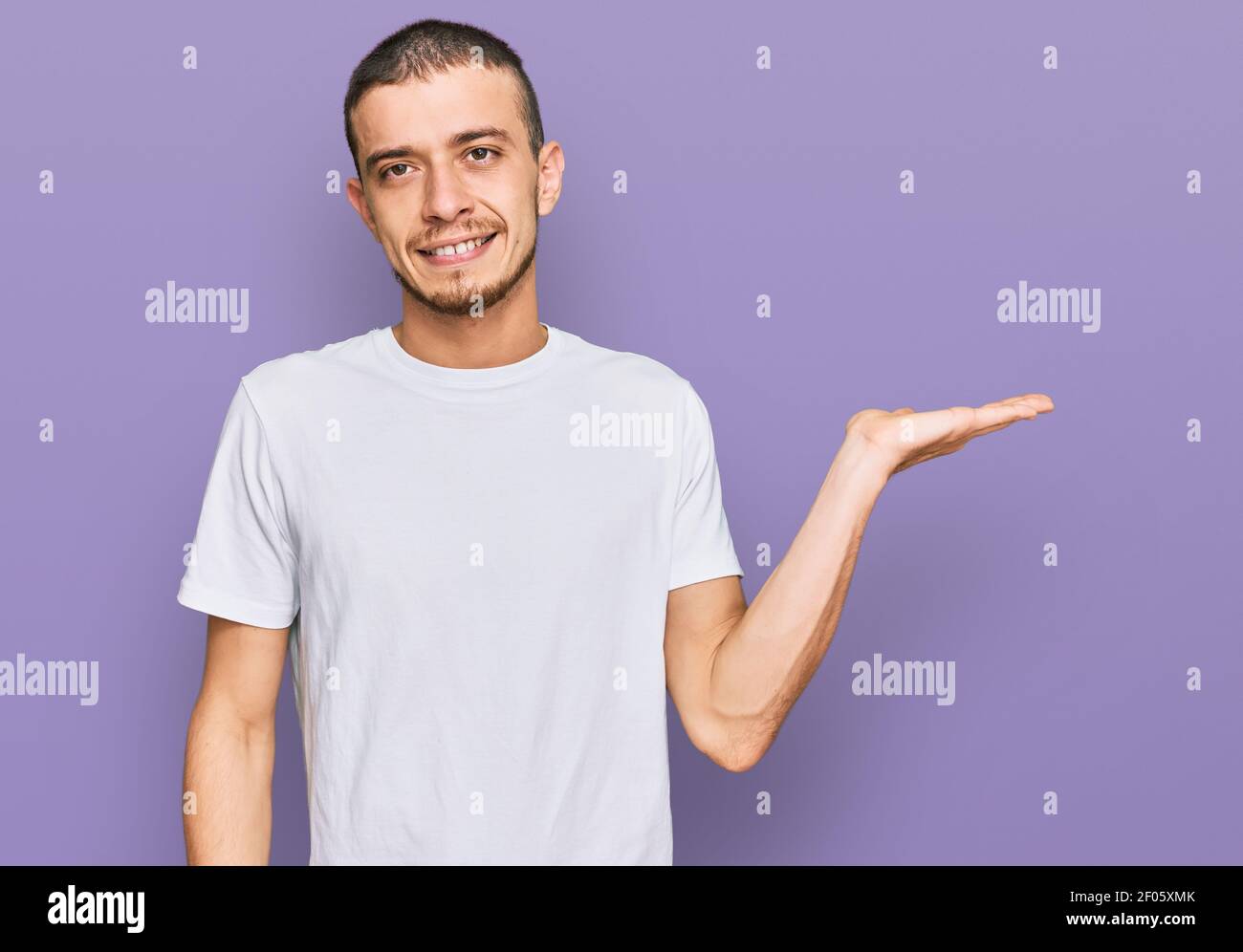 Hispanic young man wearing casual white t shirt smiling cheerful ...