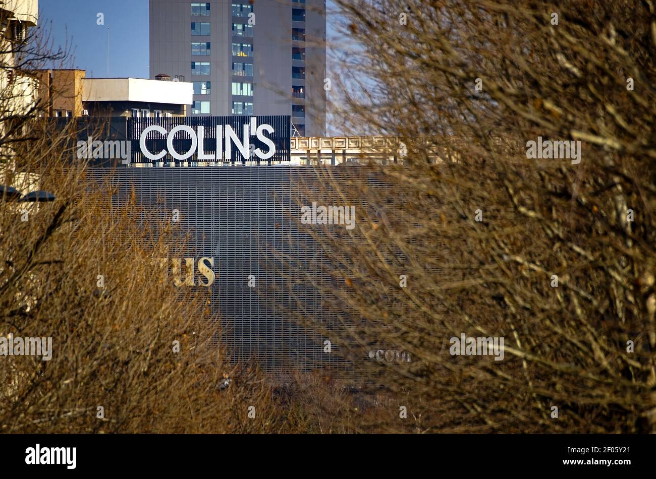 Bucharest, Romania - February 26, 2021: A logo of Colin's Jeans Turkish fashion company is displayed on top of the Unirea Shopping Center building in Stock Photo