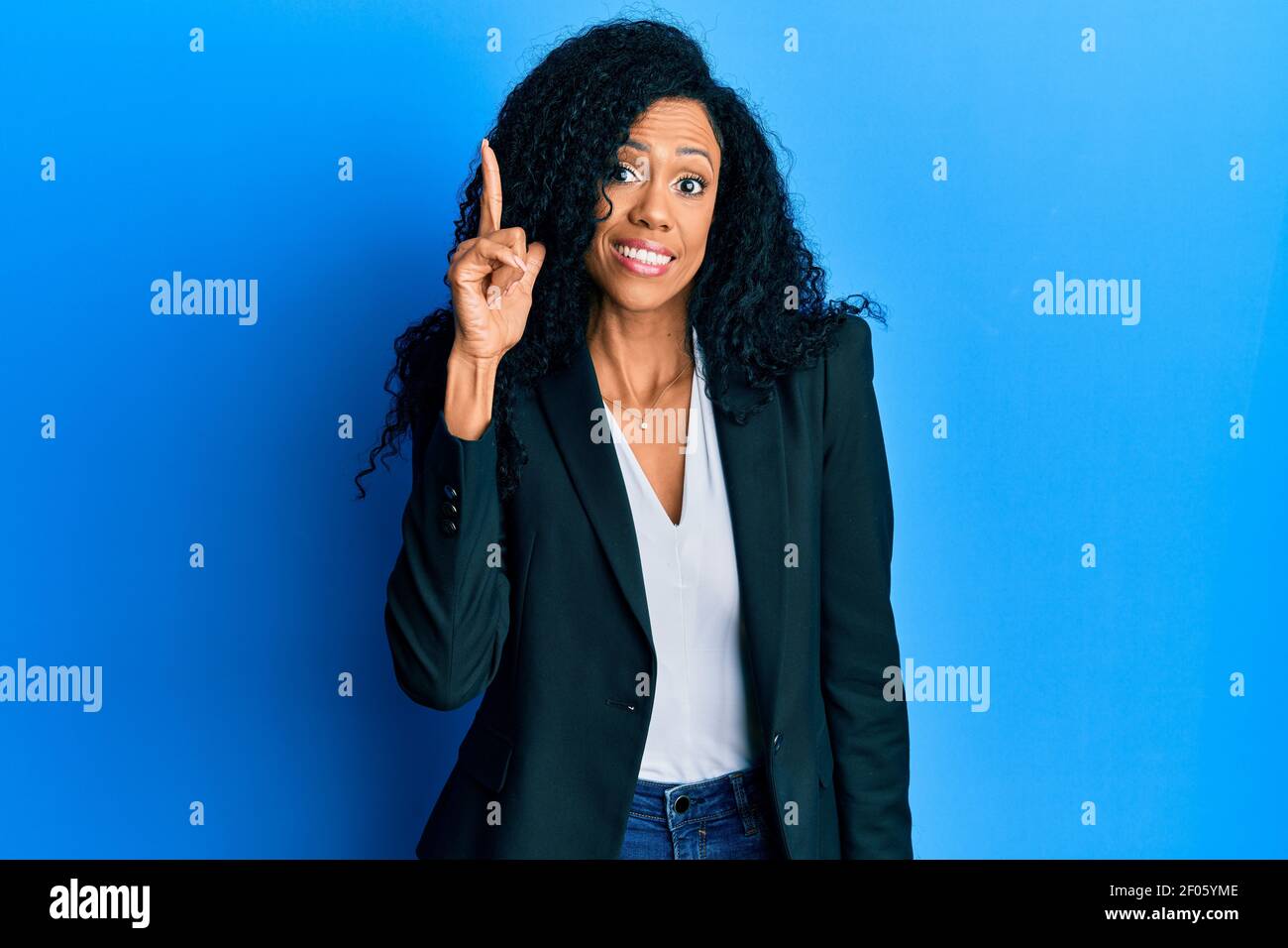 Middle age african american woman wearing business clothes pointing ...