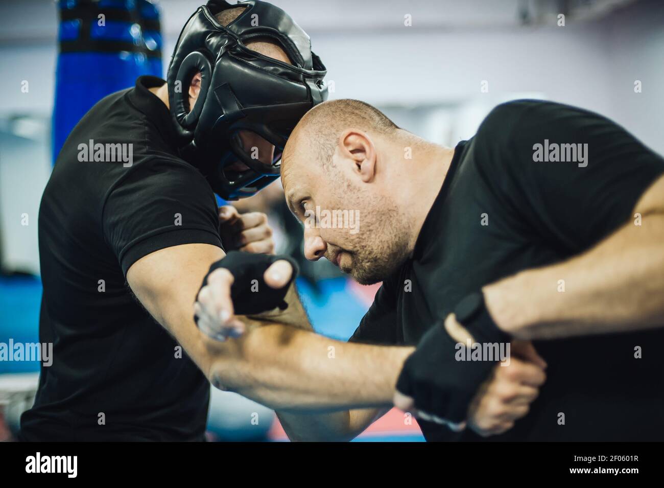 Instructor demonstrate headbutt street fight technique against attacker
