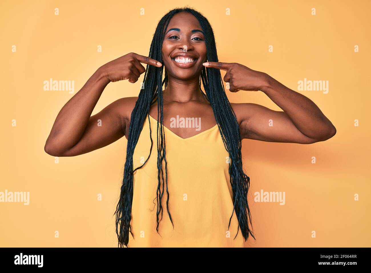African american woman with braids wearing casual clothes smiling ...