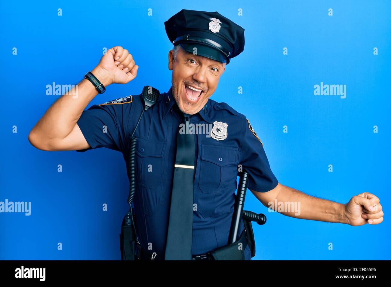 Handsome middle age mature man wearing police uniform dancing happy and  cheerful, smiling moving casual and confident listening to music Stock  Photo - Alamy