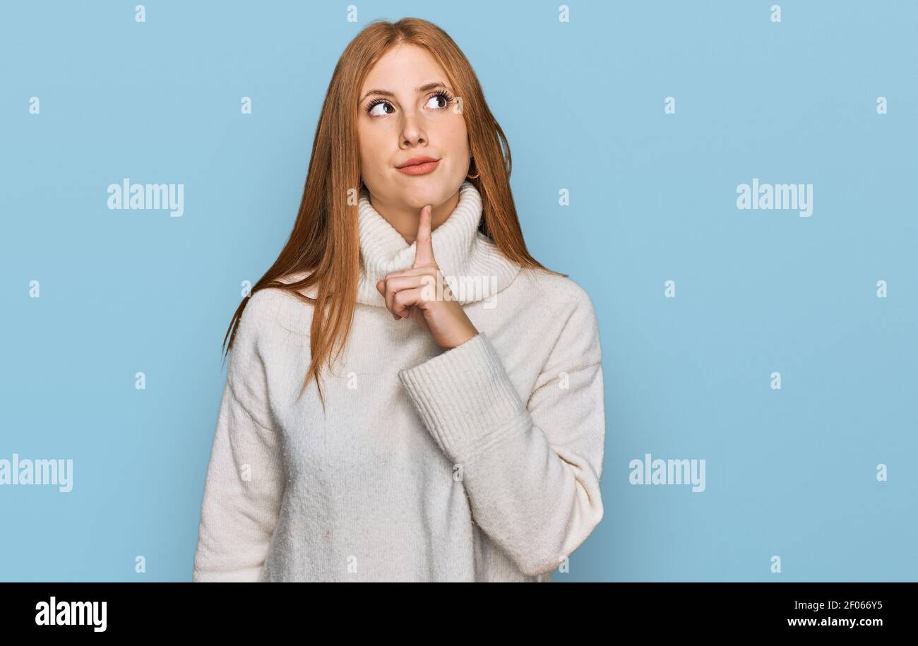 Young irish woman wearing casual winter sweater thinking concentrated about  doubt with finger on chin and looking up wondering Stock Photo - Alamy