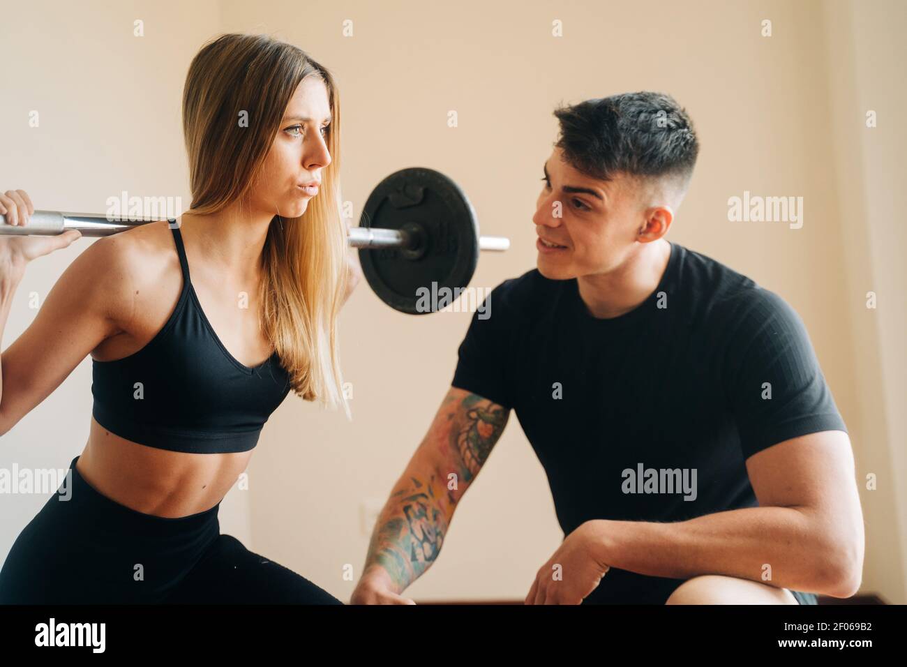 doing barbell back squat exercise 