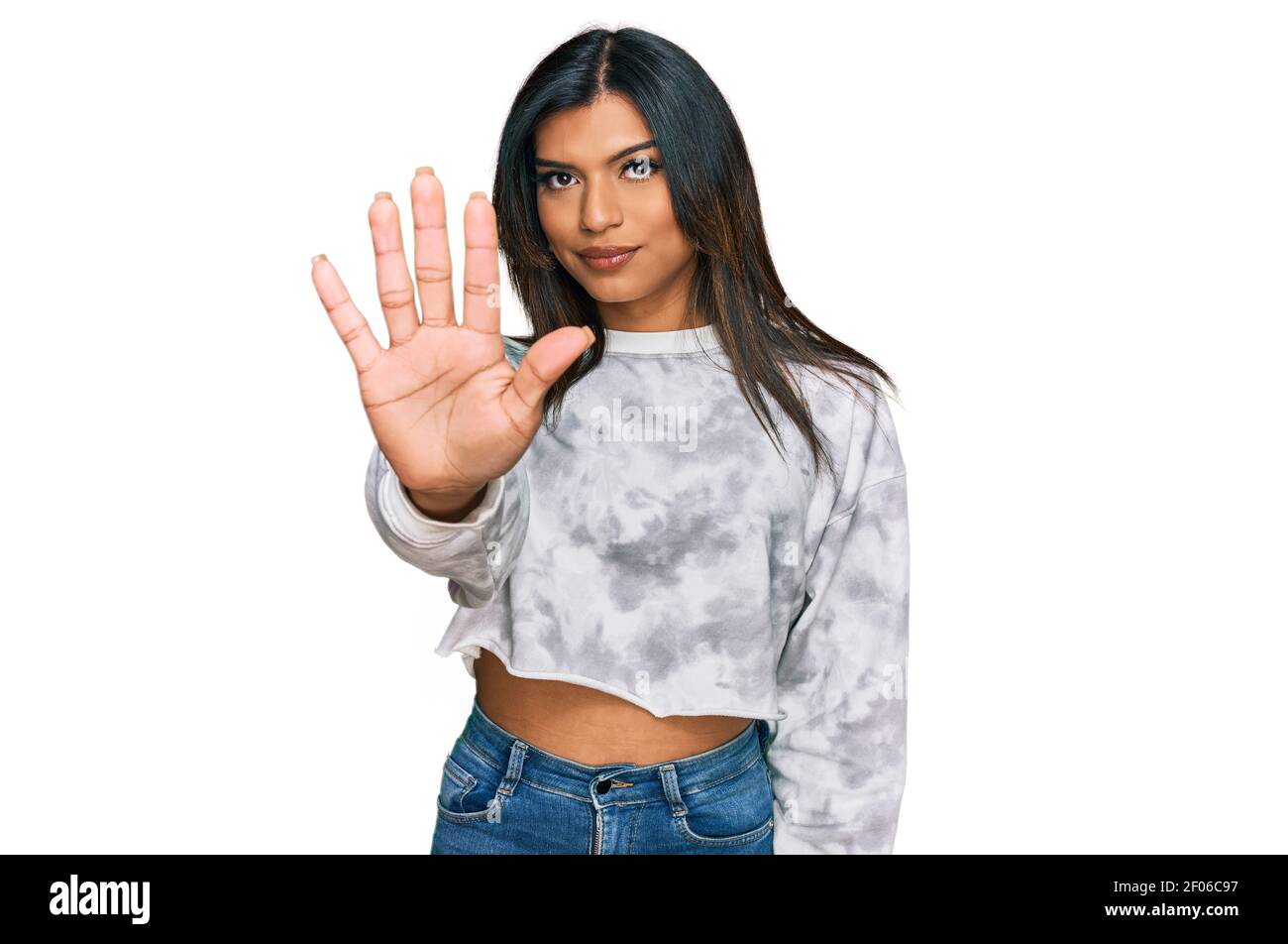 Young latin transsexual transgender woman wearing casual clothes doing stop sing with palm of the hand. warning expression with negative and serious g Stock Photo