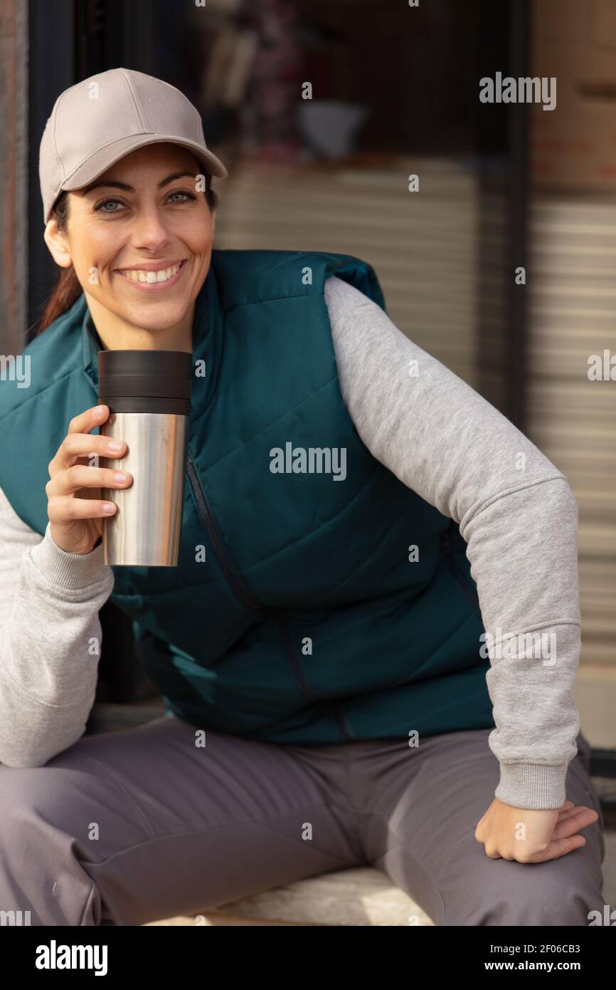 portrait of happy young female construction worker having coffee Stock Photo
