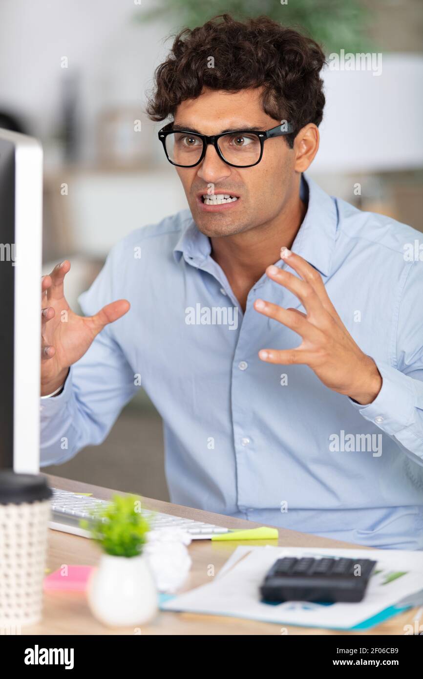 frustrated young businessman sitting at the office Stock Photo