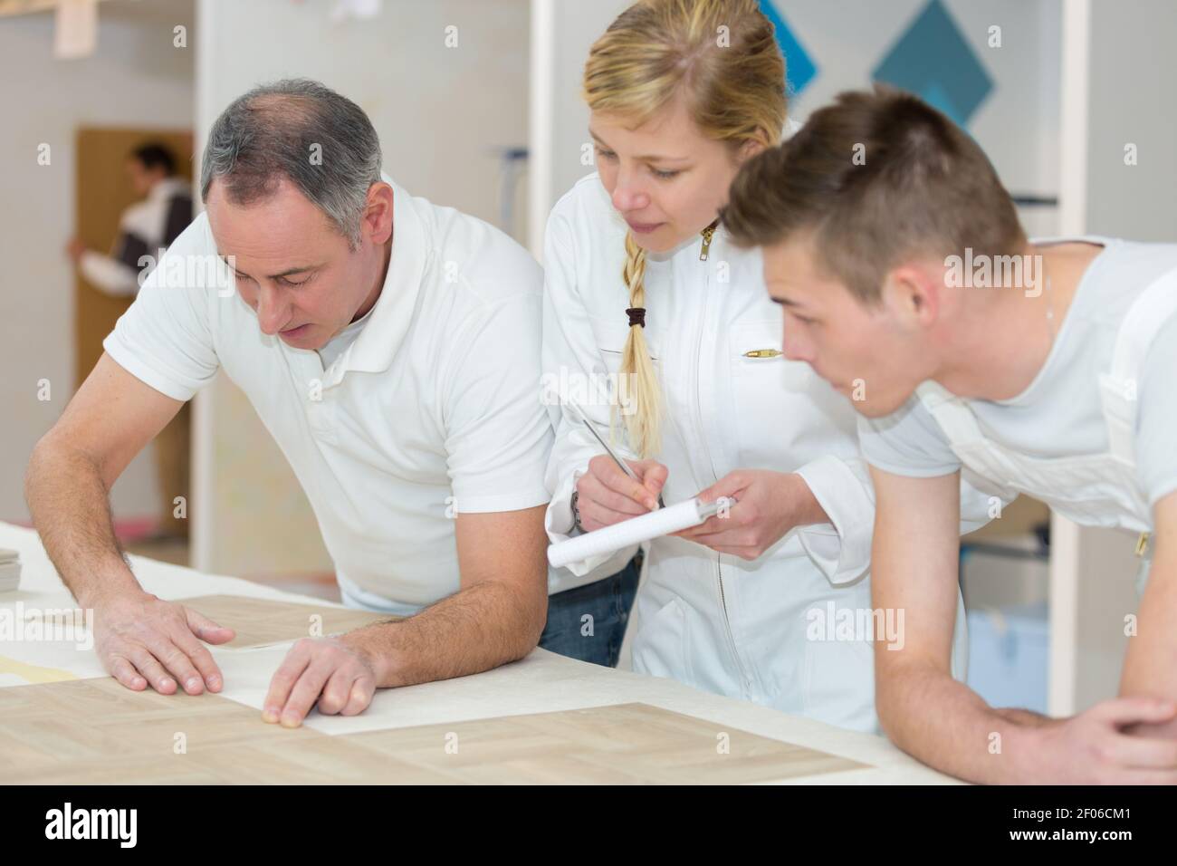 female and male apprentices with teacher Stock Photo