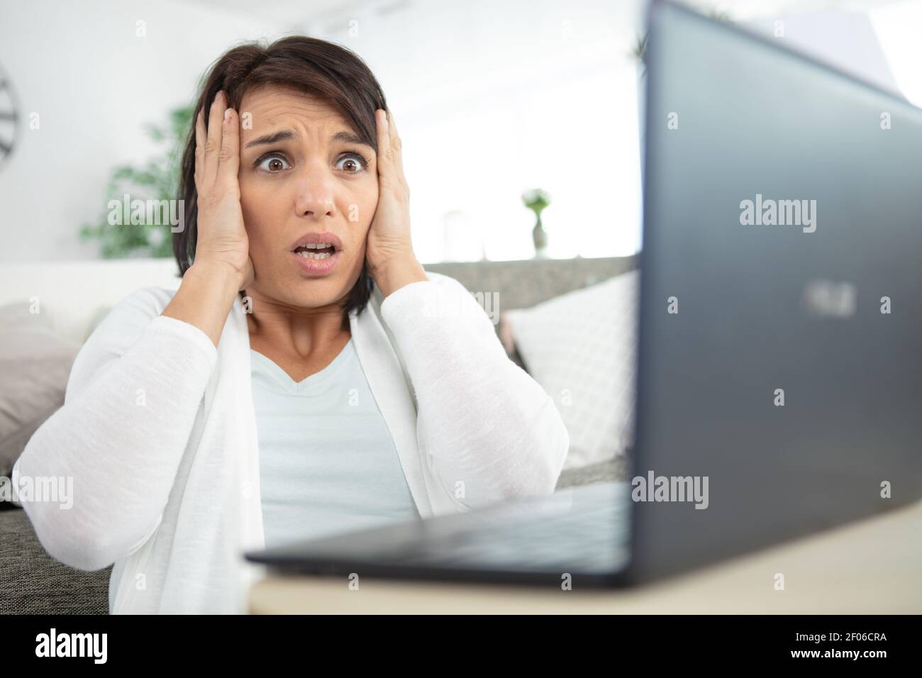 woman grabbing her head following computer malfunction Stock Photo Alamy