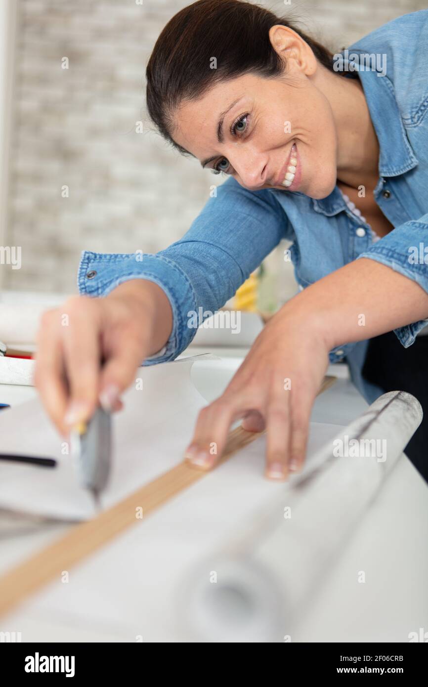happy woman preparing for wallpaper work Stock Photo