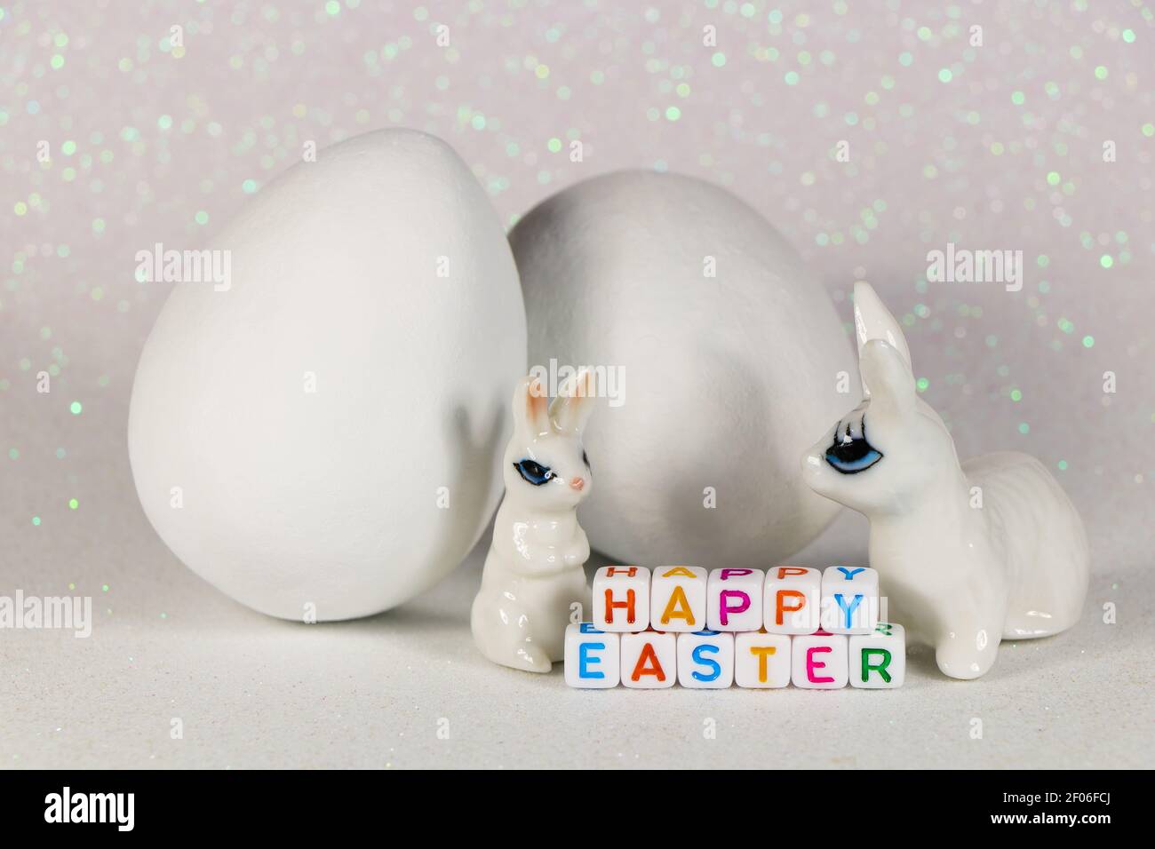 Happy Easter Bunnies With Large White Eggs Stock Photo