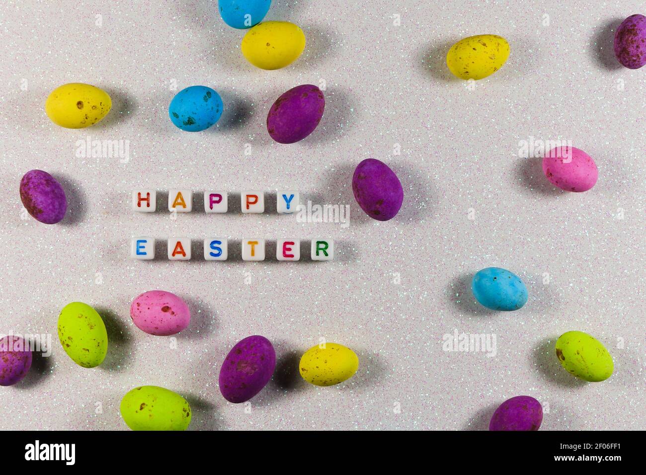Happy Easter Text Beads With Candy Eggs Layout Stock Photo