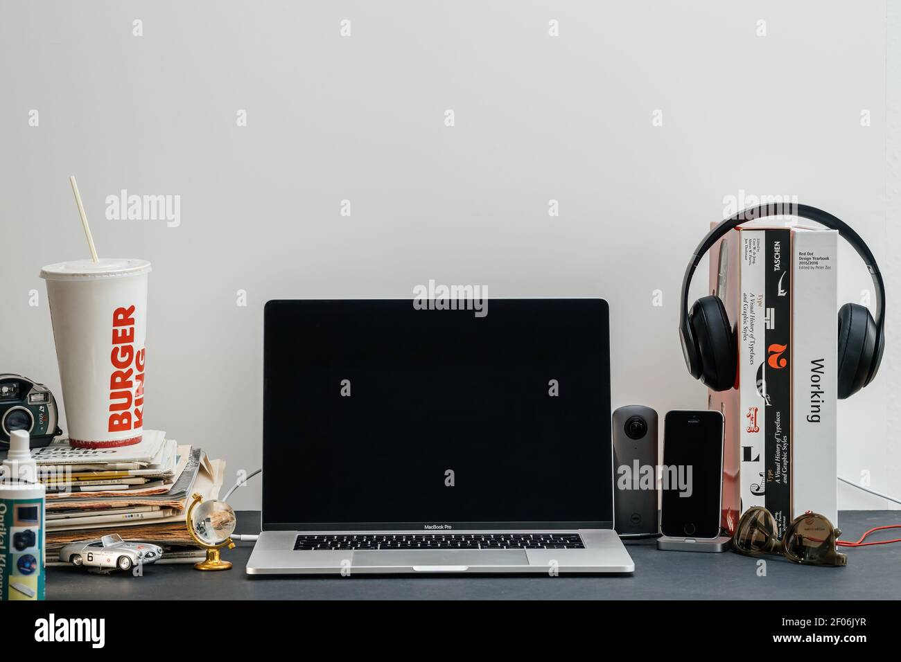 Paris, France - Sep 13, 2018: New Apple Computers MacBook Pro M1 M2 16 inch laptop in geek creative room environment with multiple design books, camera, smartphones and Dr Dre Beats Pro headphones Stock Photo