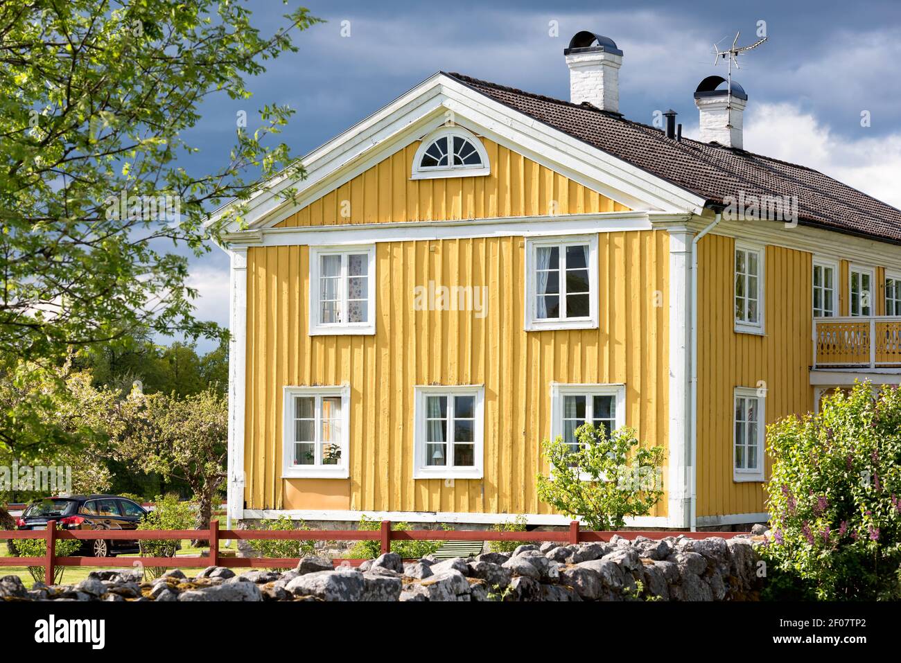Old yellow painted farm house in Sweden Stock Photo