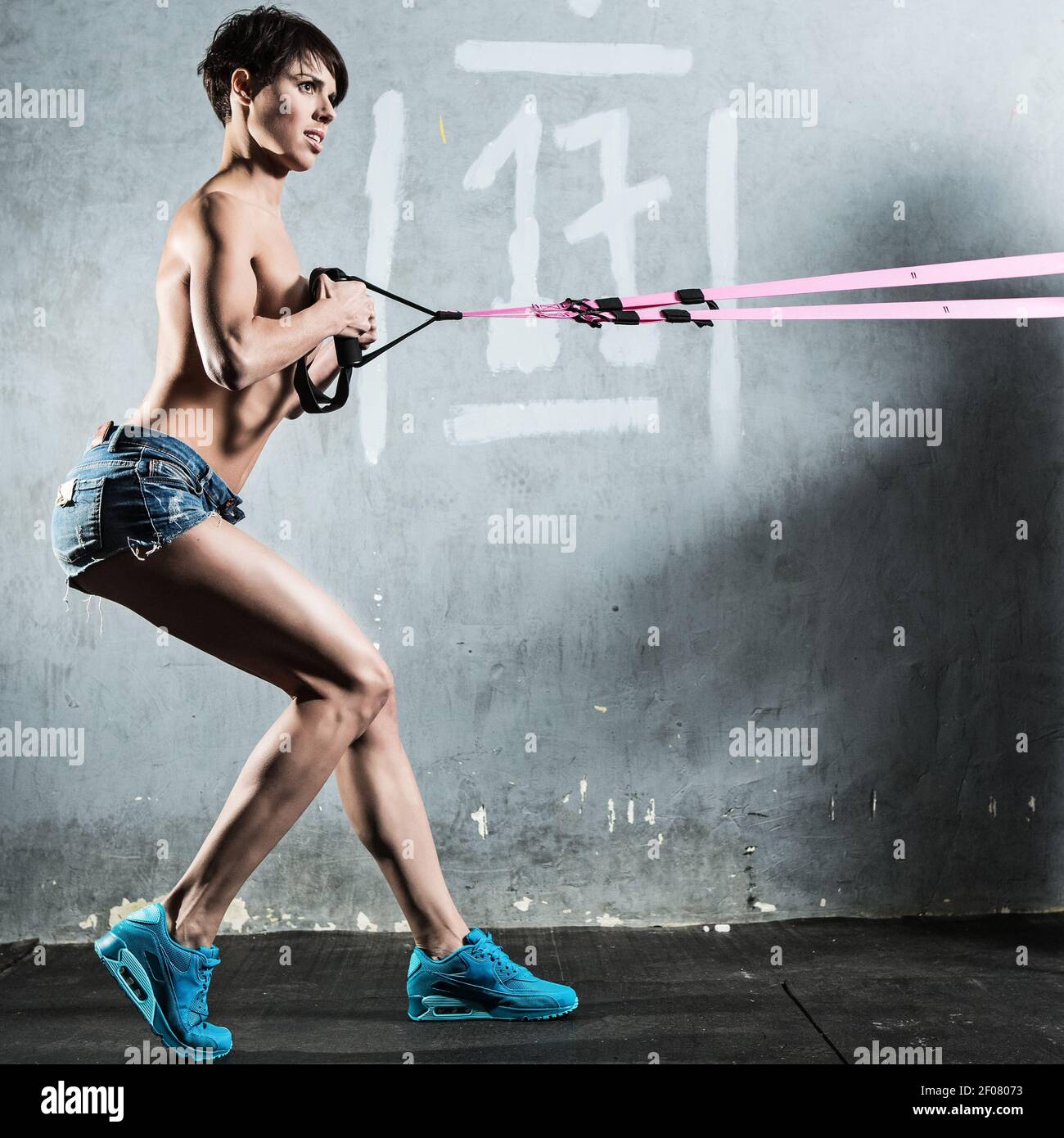 TRX. Beautiful girl in the gym Stock Photo