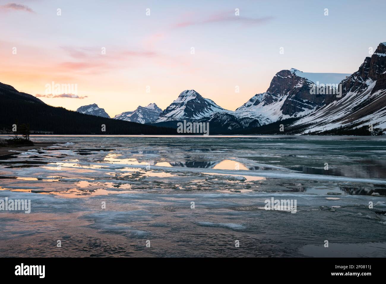 Melting ice on Bow Lake in Banff National Park during sunrise with the ...