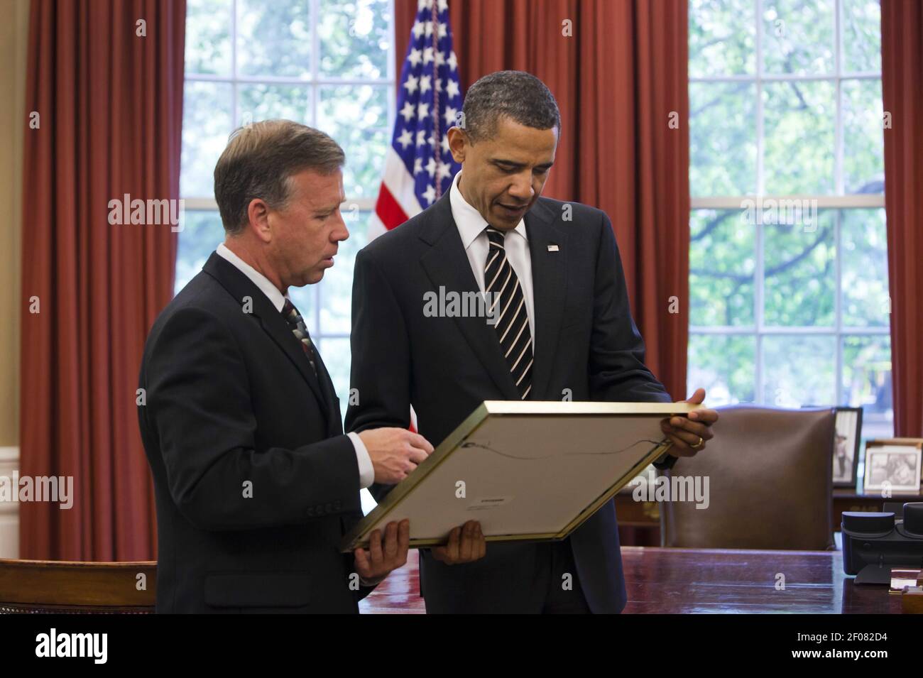 12 August 2011 Ã Washington, D.C. Ã Green Bay Packers Player Charles  Woodson presents an ownership share to President Barack Obama during an  event to honor the Super Bowl XLV champions at