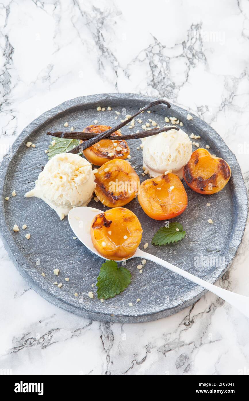 Grilled nectarines with ice cream Stock Photo Alamy
