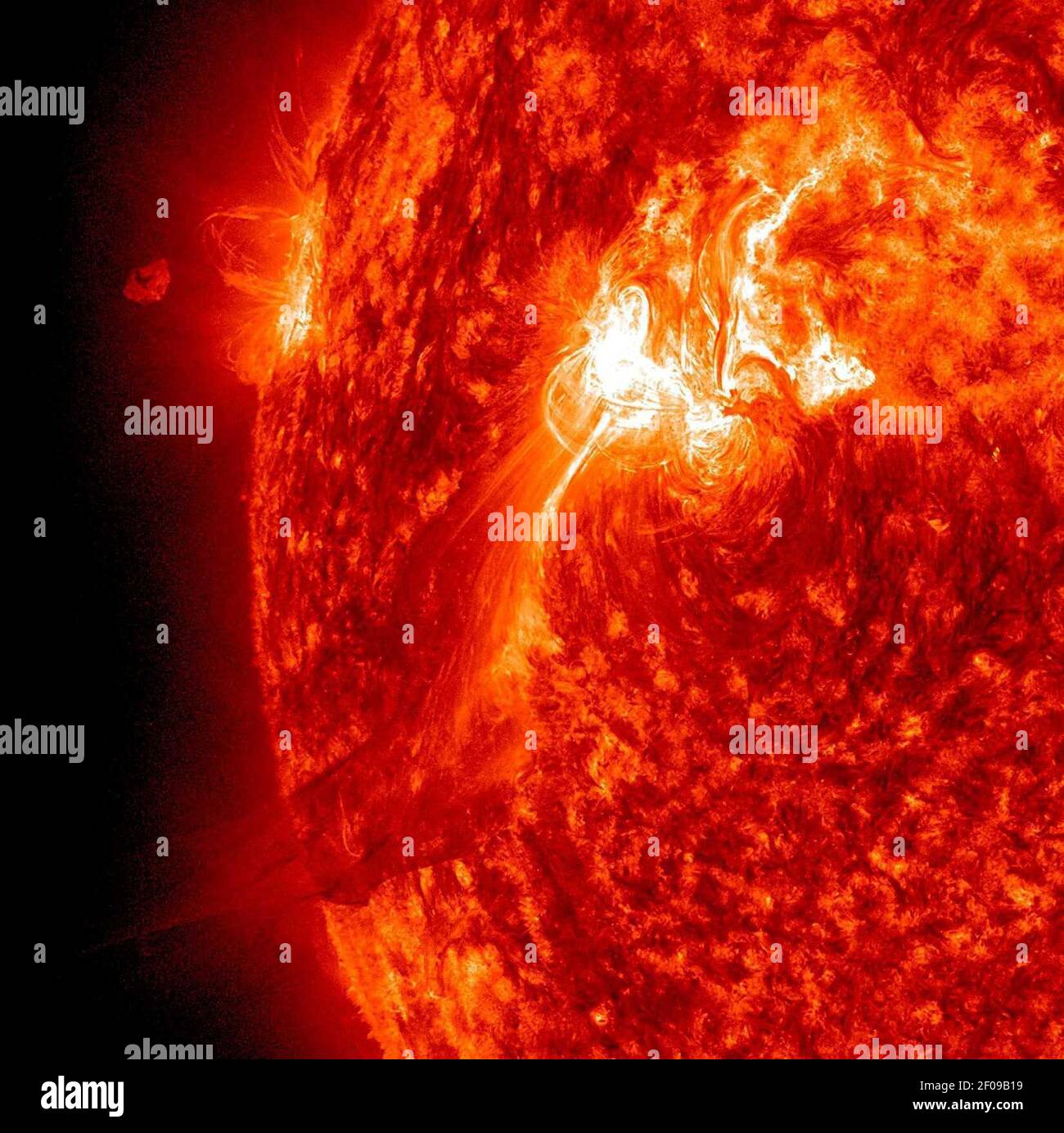 25 September 2011 - The Sun popped off an M-Class (moderate level) flare on Sept. 25, 2011 that sent a plume of plasma out above the Sun, but a good portion of it appeared to fall back towards the active region that launched it. TWith an image every minute, every nuance of graceful motion can be observed in wonderful detail. The bright flash shows the flare itself erupting. Since this event, this active region has been the source of several large flares and many lesser ones that have caused geo-effective storms on Earth as it has rotated around towards facing us. Photo Credit: NASA/SDO/Sipa Pr Stock Photo