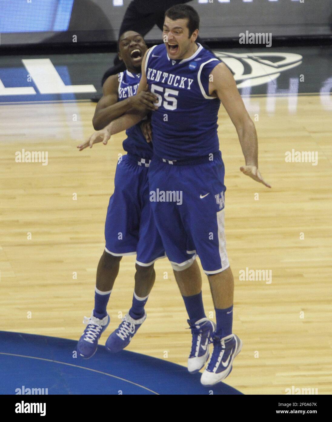 Kentucky's Stacey Poole Jr., left, and Josh Harrellson (55) celebrate at  the end of their Elite 8 game against North Carolina in the men's NCAA East  Regional Championship on Sunday, March 27,
