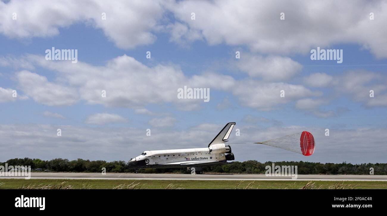 With its drag chute deployed space shuttle Discovery, STS-133, ends its ...