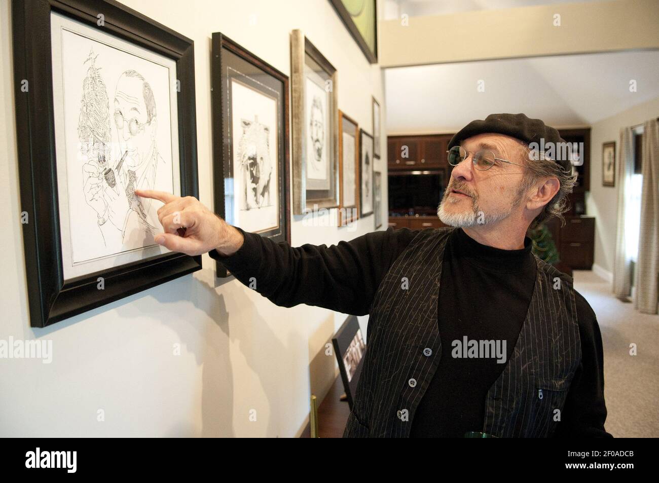 Joe Castillo, of Richmond, Kentucky, looks at one of his drawings