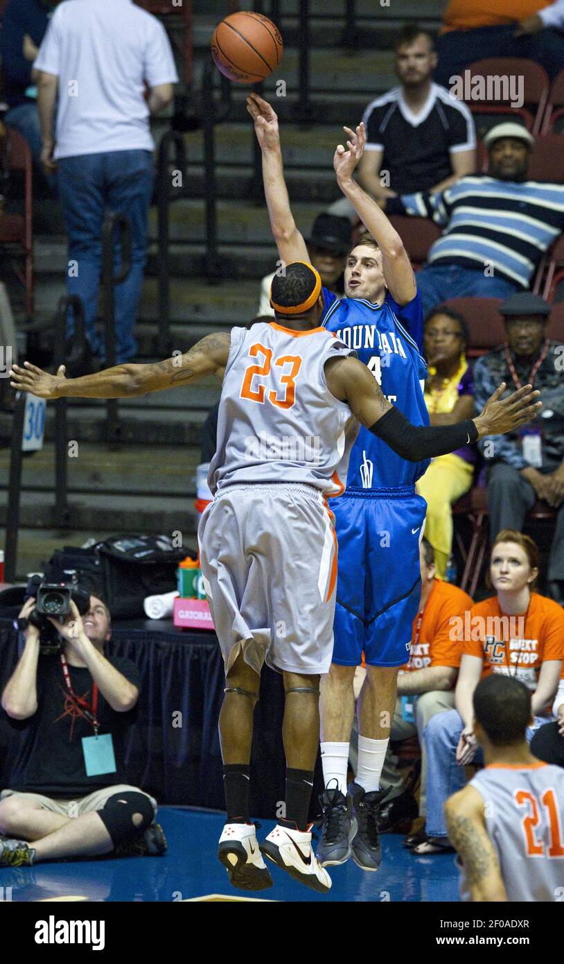 Mountain State's Cam Miller takes a shot over Pikeville's Quincy Hankins- Cole (23) during the NAIA Division I men's college basketball championship  game at Municipal Auditorium in Kansas City, Missouri, on Tuesday, March