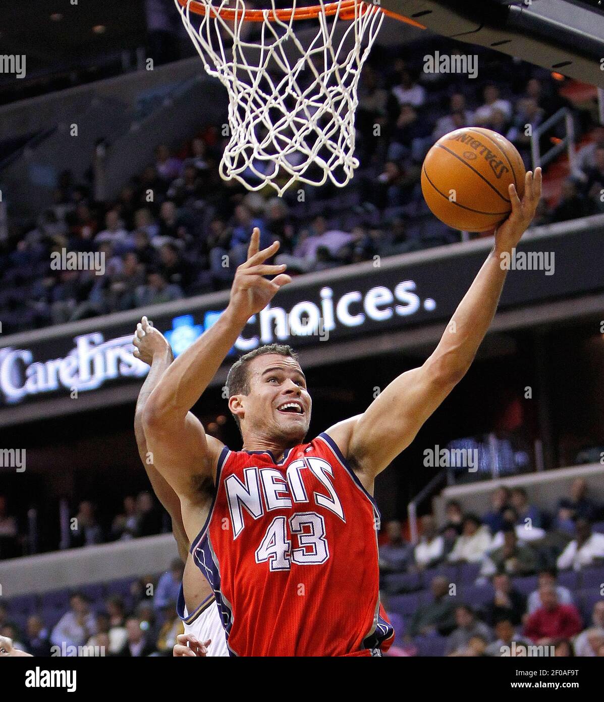 New Jersey Nets forward Kris Humphries (C) passes the ball as Chicago Bulls  center Omer Asik (L) and forward Brian Scalabrine defend during the second  quarter at the United Center on January